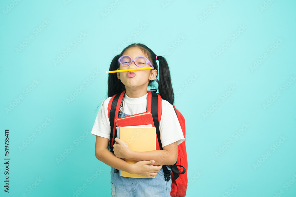 Close-up kid students girl smiling holding book, going to school. Close-up kid students girl smiling holding book, going to school.