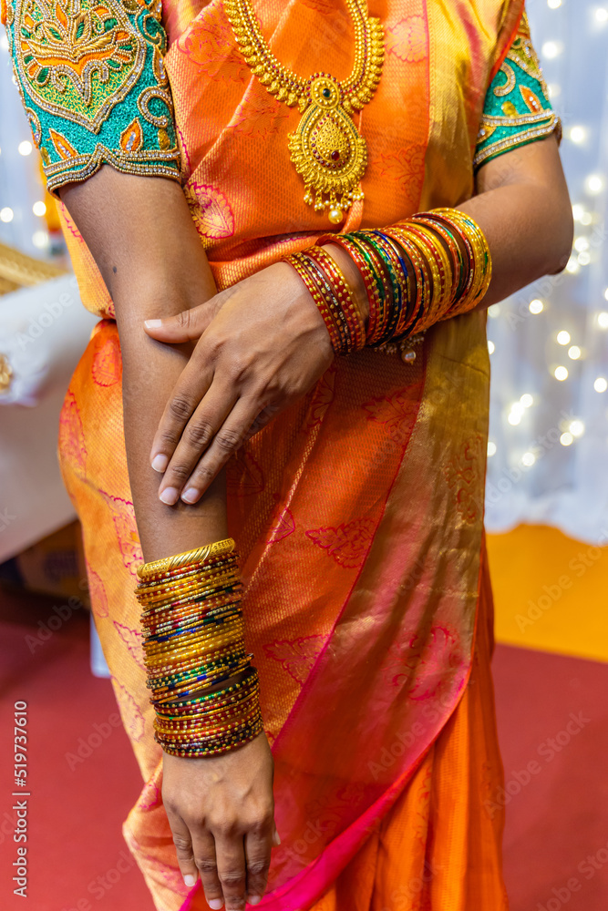 South Indian Tamil bride's wearing her traditional bangles hands close up