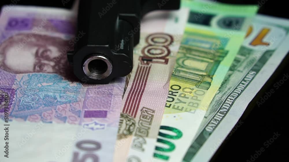 Pistol Gun on Ukrainian Hryvnia, Russian Rubles, Euro and US Dollars Banknotes. War Economy and Inflation Concept, Close Up Pistol Gun on Ukrainian Hryvnia, Russian Rubles, Euro and US Dollars Banknotes. War Economy and Inflation Concept, Close Up