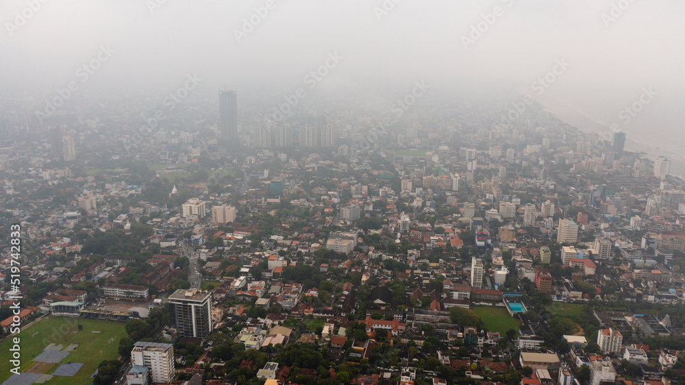 Top view of city of Colombo with skyscrapers in the fog.