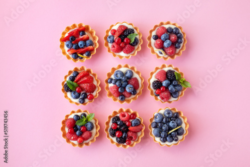 Set of different tartlets or cake with cream cheese, honey and summer berry. Pastry dessert top view. Flat lay.