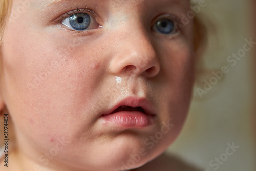 a child with snot,portrait of a little girl crying with snot photo