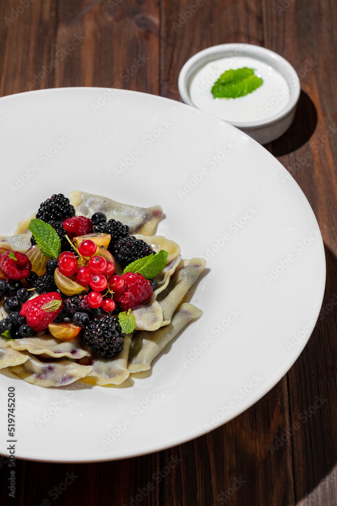 Dumplings with raspberries, kumquats, blackberries Dumplings with raspberries, kumquats, blackberries