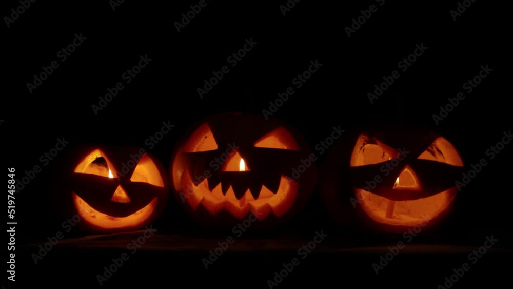 Halloween pumpkins in the dark seeng on camera with angry smile and candle inside waiting for holiday coming. Halloween pumpkins in the dark seeng on camera with angry smile and candle inside waiting for holiday coming.