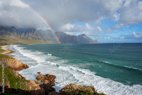 View with rainbow towards Rooi Els and Hanklip from Clarence Drive on the eastern side of False Bay. Cape Town, Western Cape, South Africa. photo