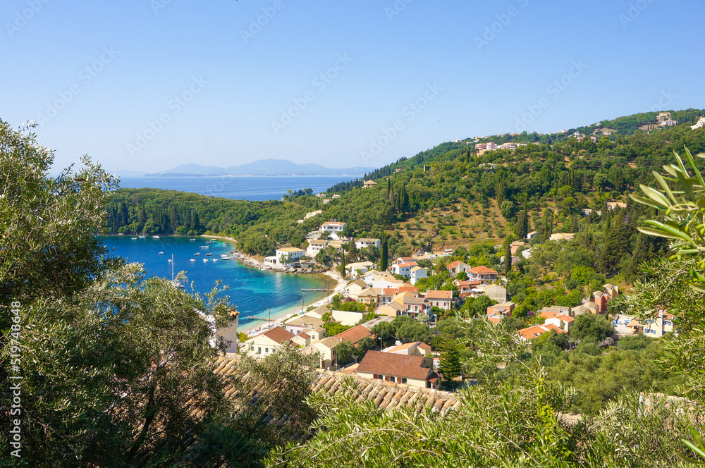 Coastial village on Corfu island sourrounded with greenery