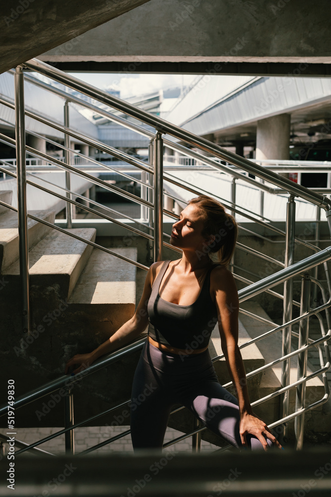 Portrait of young woman in sportswear resting during her workout. Healthy habits. Portrait of young woman in sportswear resting during her workout. Healthy habits.