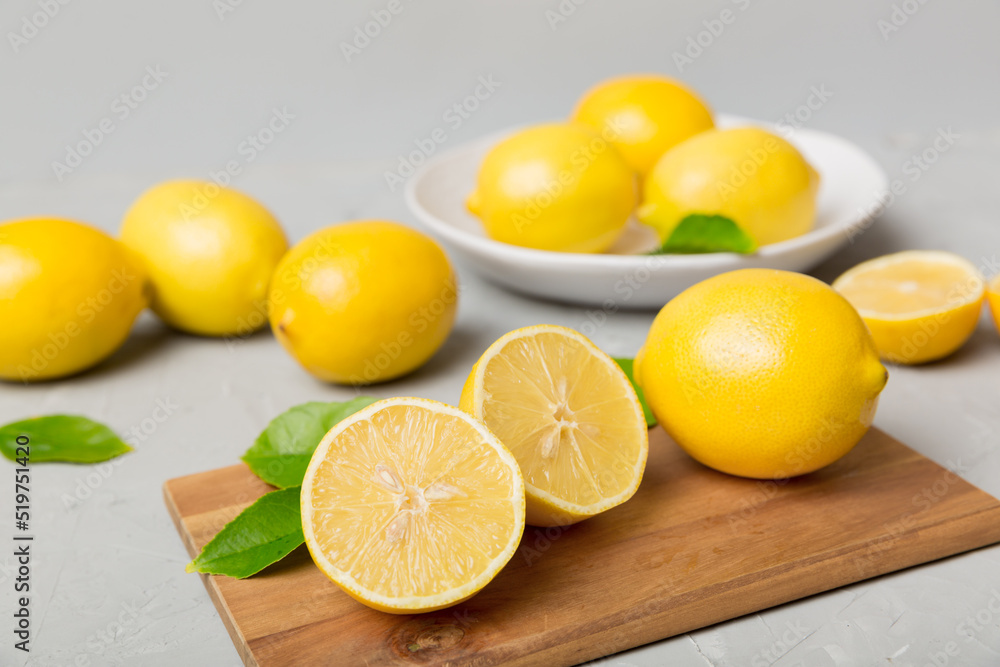 Top view with copy space for fresh and ripe lemons on cutting board. Healthy food background. Elegant background of lemon and lemon slices with squeezer colored background Top view with copy space for fresh and ripe lemons on cutting board. Healthy food background. Elegant background of lemon and lemon slices with squeezer colored background