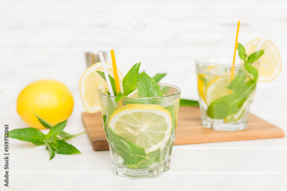 Foto Stock Mojito cocktail. Refreshing mojito cocktail with lime, lemon and  mint in a tall glass with a stick | Adobe Stock