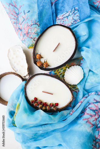 original handmade soy wax candle in coconut, palm branch and sea shells. marine theme