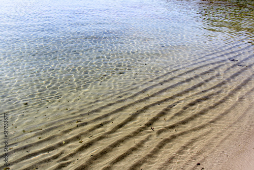Sand ripple patterns formed under water at the beach side