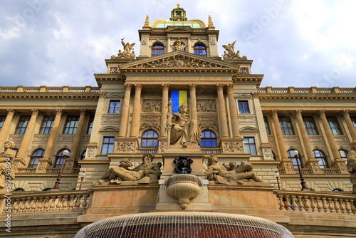 Canvas Print Old ancient building of National Museum Prague with Ukrainian flag on facade in