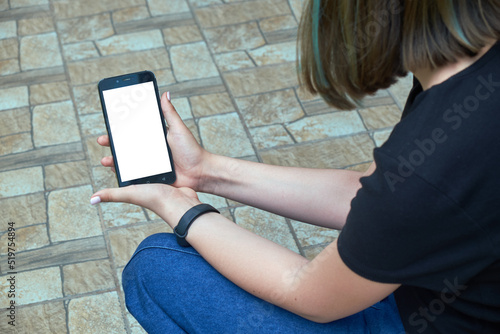 Obraz na płótnie Young girl holding smartphone with white screen w salonie
