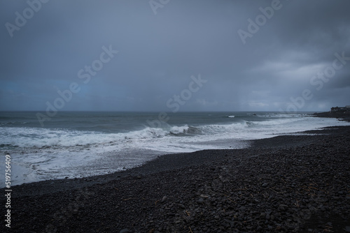 Sao Vicente, Portugal October, 2021: Black rocky beach at Sao Vicente, on the Northern Coast of Madeira. Dramatic stormy weather. © Сергій Вовк