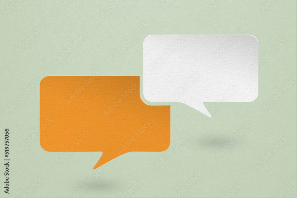 two blank white and orange speech bubble paper cut , on grunge green paper background. Conceptual image about communication and social media two blank white and orange speech bubble paper cut , on grunge green paper background. Conceptual image about communication and social media