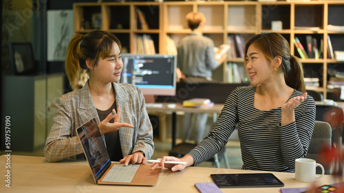 Two young software developers are brainstorming for new web site project together