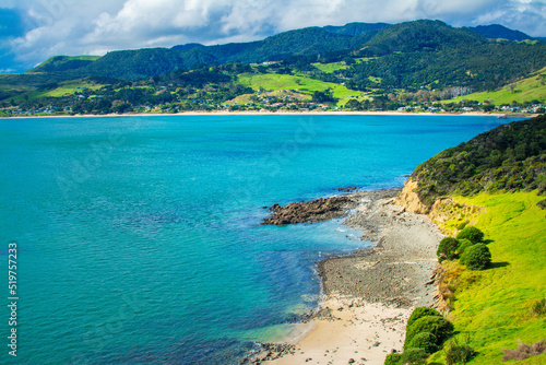 Aerial view over Hokianga Harbour surrounded by lush green hills and sandy beaches. Iconic New Zealand, Northland © Irina B