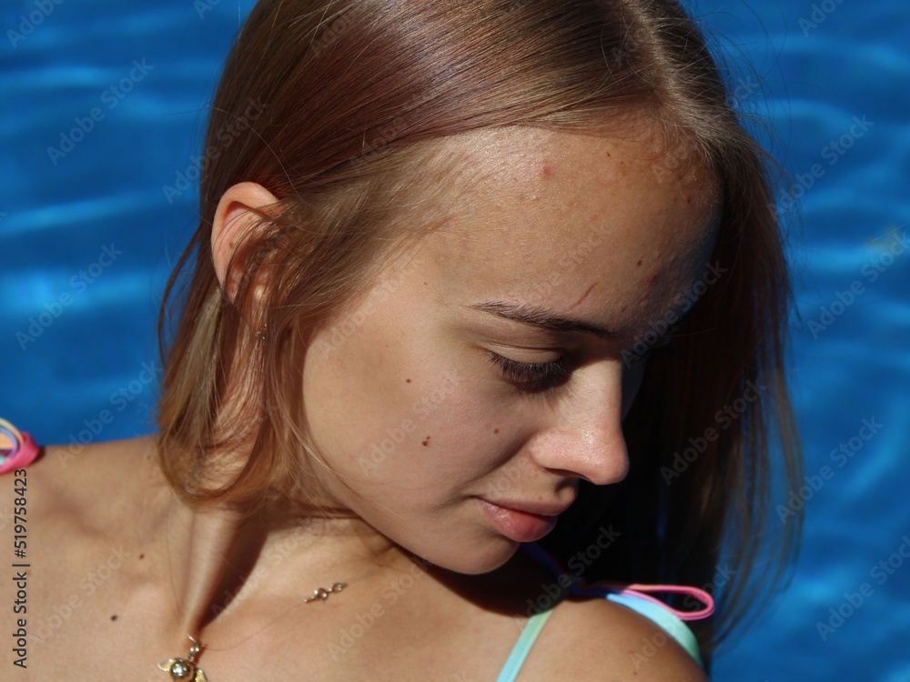 attractive and sexy girl with a beautiful ass in a bikini is relaxing by the pool attractive and sexy girl with a beautiful ass in a bikini is relaxing by the pool