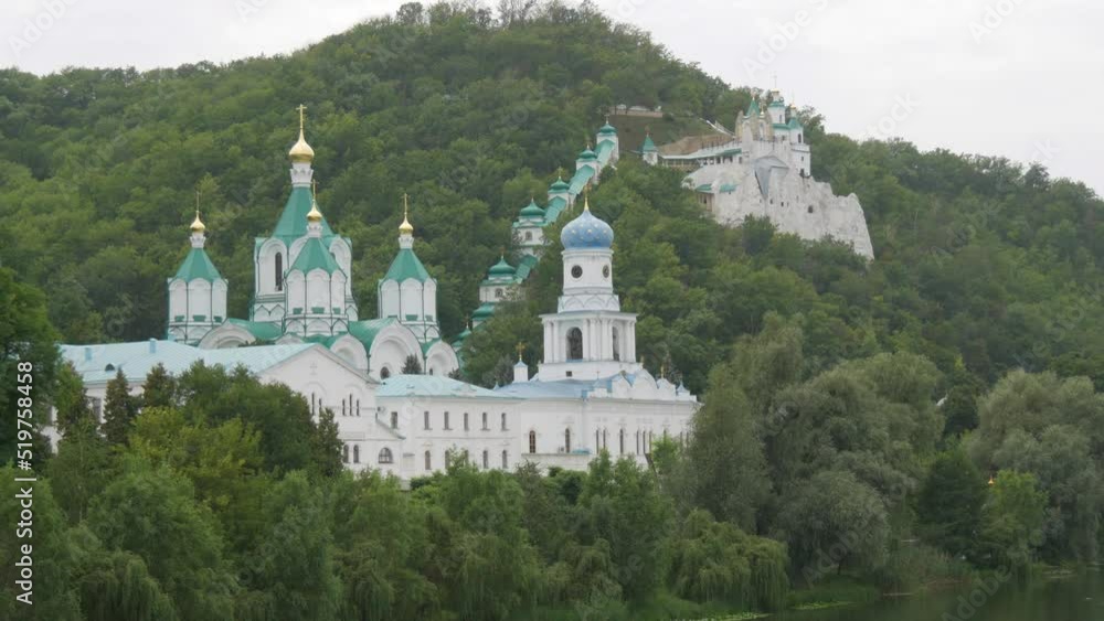 Svyatogorsk Lavra, Donetsk region, Ukraine. A beautiful old monastery is located in the valley of the Seversky Donets River on a mountain around the green foliage of trees Svyatogorsk Lavra, Donetsk region, Ukraine. A beautiful old monastery is located in the valley of the Seversky Donets River on a mountain around the green foliage of trees
