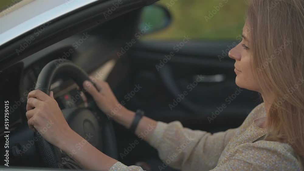 girl with a calm face driving a convertible. side view girl with a calm face driving a convertible. side view