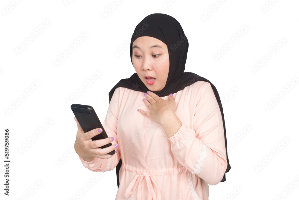 A woman wearing a hijab and wearing a light pink dress is shocked when she sees the contents of her cellphone A woman wearing a hijab and wearing a light pink dress is shocked when she sees the contents of her cellphone