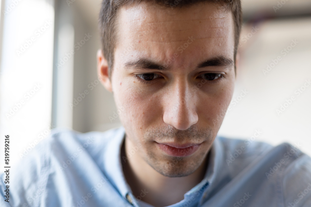 Fototapeta premium Close up of worried young businessman checking out bills, financial problem.