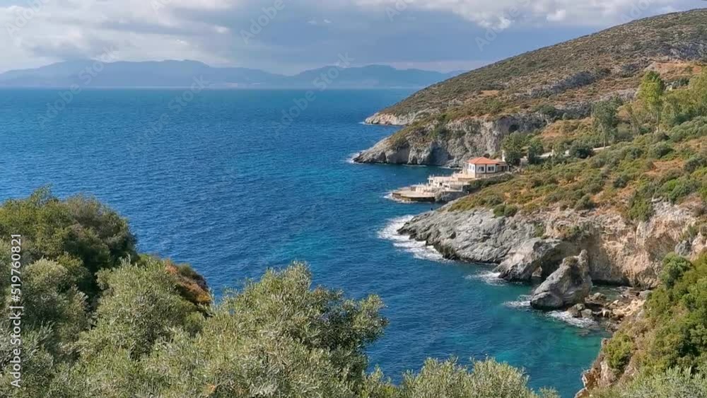 View of the picturesque coastline of the Aegean coast with rocks and greenery. The Aegean Sea, Turkey, Kusadasi.