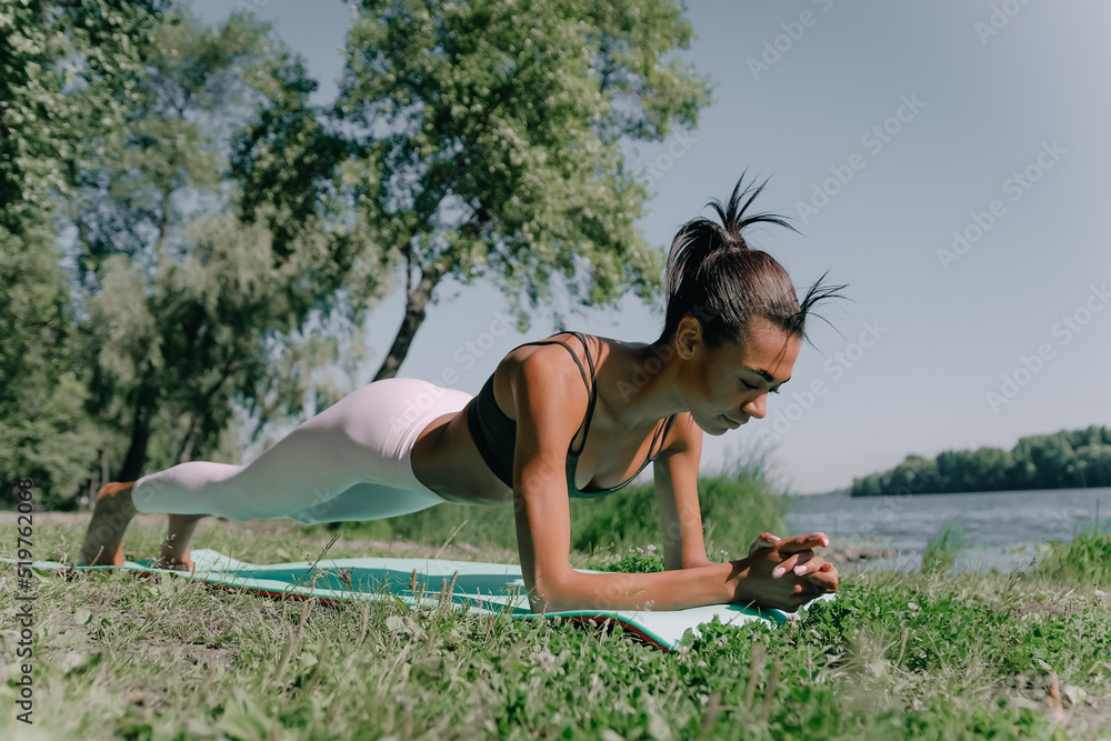young african woman in plank position, exercising outdoors. stretch whole body, lead healthy lifestyle