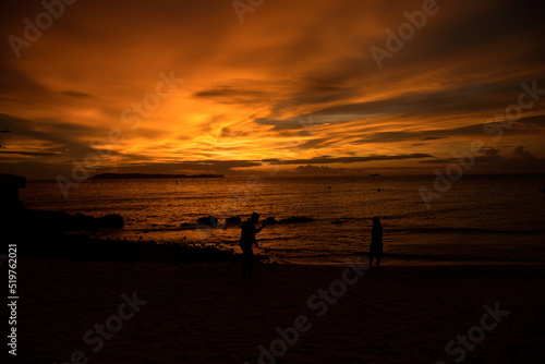 Couple at the Beach ---   picture of a couple making photos at sunset on a beach in Thailand