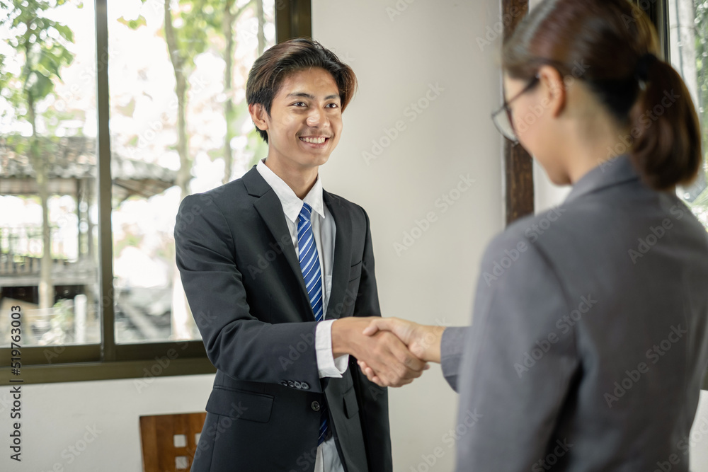 The businessmen shake hands after the meeting was successful and agreed upon The businessmen shake hands after the meeting was successful and agreed upon