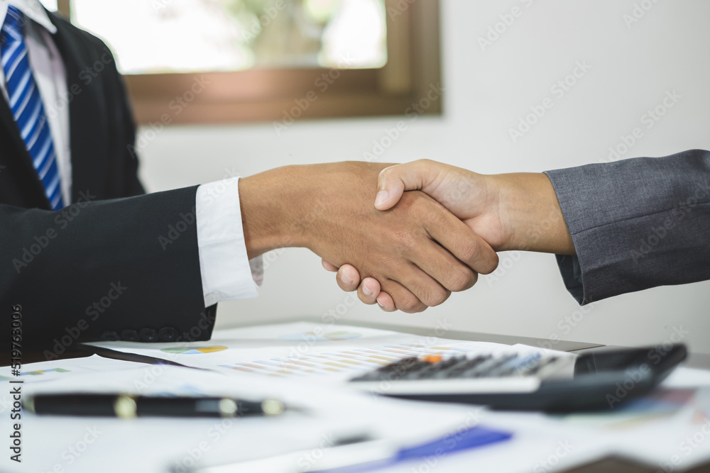 The businessmen shake hands after the meeting was successful and agreed upon