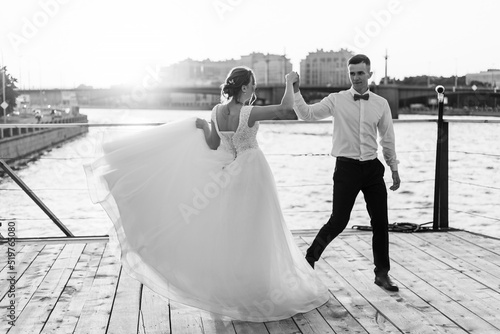 Fototapeta Naklejka Na Ścianę i Meble -  The dance of the bride and groom. Wedding article. A happy couple. Love. Photos for printed products.