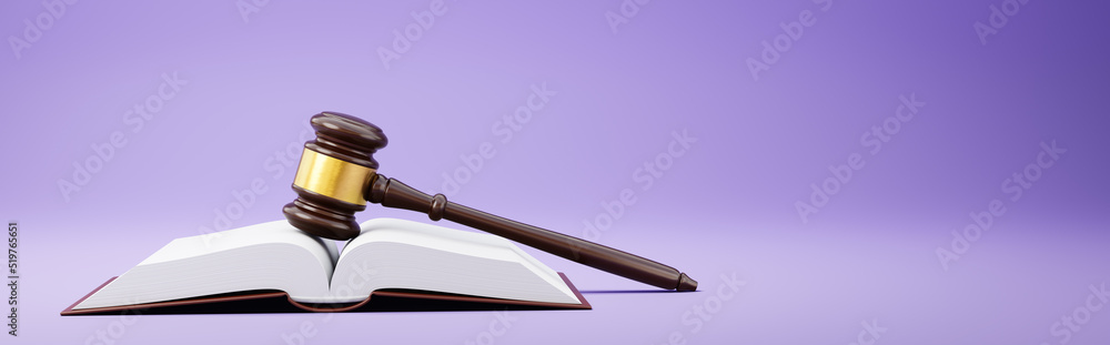 Judge's Gavel and an Open Book on Purple Background Judge's Gavel and an Open Book on Purple Background