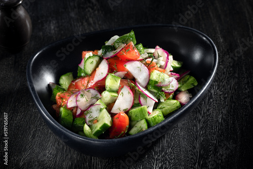  close up view of fresh vegetable salad on grey background