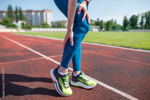 Canvas Print woman runner holding her sports leg injure