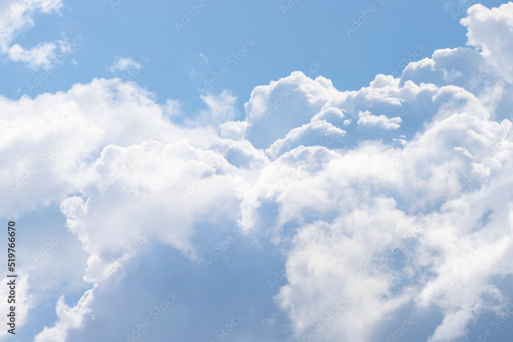 White thick and fluffy cumulus clouds in the light blue sky, close up. Beautiful cloudscape White thick and fluffy cumulus clouds in the light blue sky, close up. Beautiful cloudscape