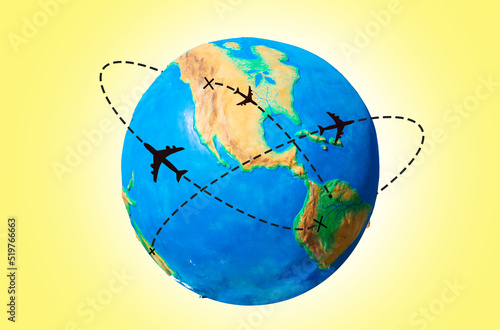 Global transportation. Globe of Earth with a silhouette of an airplanes flying along the routes. Yellow background. The concept of air travel