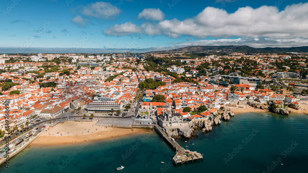 Panaromic drone aerial view of Cascais Bay, Portugal looking towards Ribeira Beach with Sintra mountains on background
