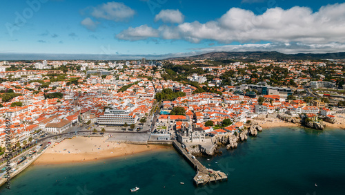 Panaromic drone aerial view of Cascais Bay, Portugal looking towards Ribeira Beach with Sintra mountains on background