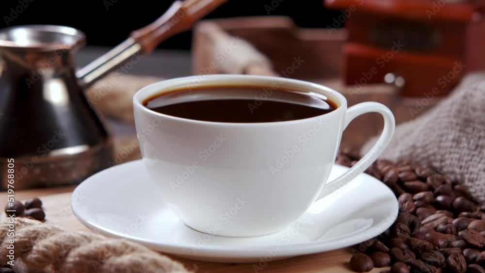 Video panning. Cup of coffee on the table, cezve and coffee grinder. Video panning. Cup of coffee on the table, cezve and coffee grinder.