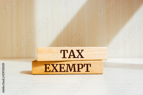 Wooden blocks with words 'Tax exempt'. Business concept photo