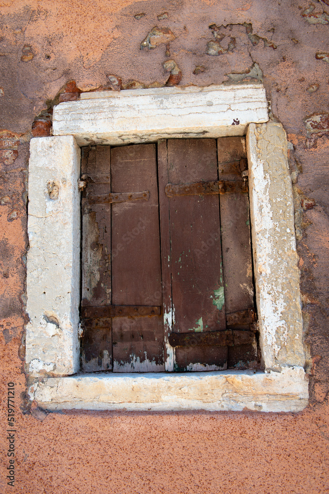 Old shuttered window and cracks in the plaster of ancient walls in Venice Old shuttered window and cracks in the plaster of ancient walls in Venice