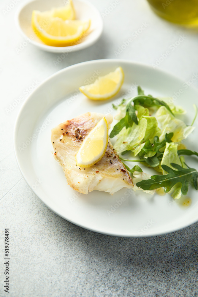 Roasted cod fillet with lemon and salad