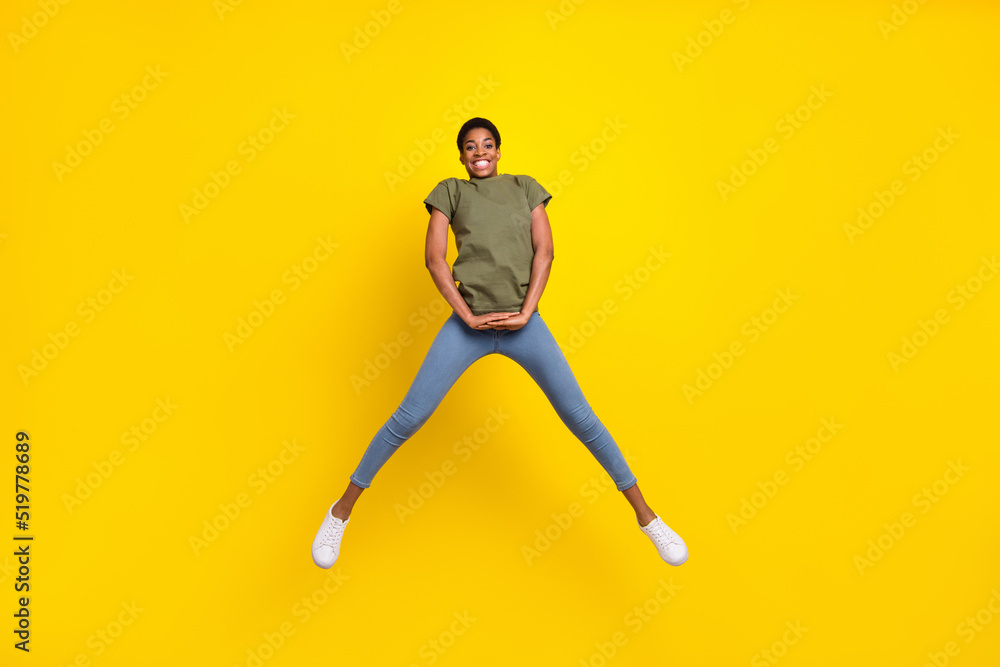 Full length photo of cheerful excited person jump have fun good mood isolated on yellow color background