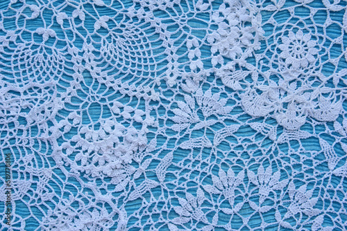 White lace on a blue textile background.

