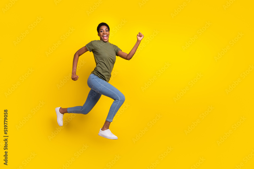 Full size photo of excited sportive person jump rush hurry fast isolated on yellow color background