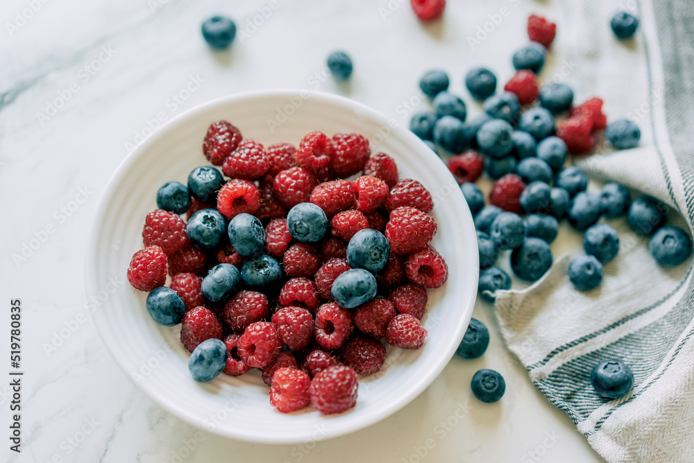 Top view of pile of fresh and healthy and berries for wellness on marble background. Top view of pile of fresh and healthy and berries for wellness on marble background.