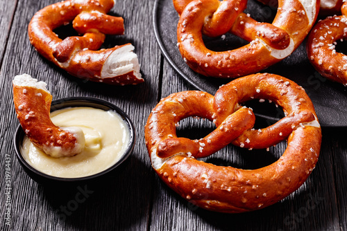 pretzels in the form of knot with cheese sauce photo