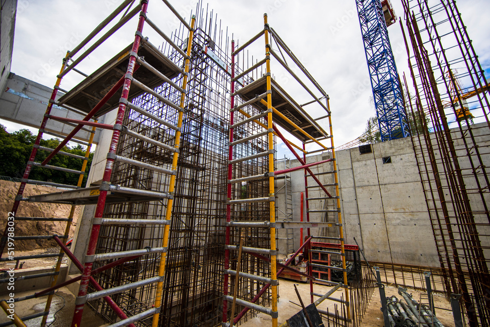 Fototapeta premium Construction site workers and crane, Many workers were building under construction building with advanced equipment and cranes.