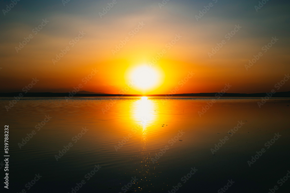 Sunset over the lake. Sun and reflection on the lake. Nature or environment Sunset over the lake. Sun and reflection on the lake. Nature or environment